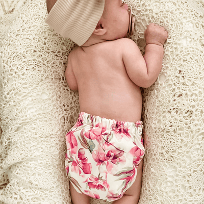 baby girl wearing a floral pink orchid print reusable cloth anppy #color_eliza